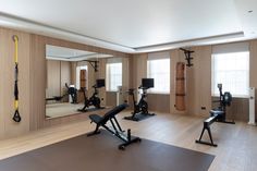 an empty gym with exercise equipment and mirrors