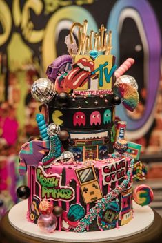 a multi - tiered cake decorated with colorful decorations