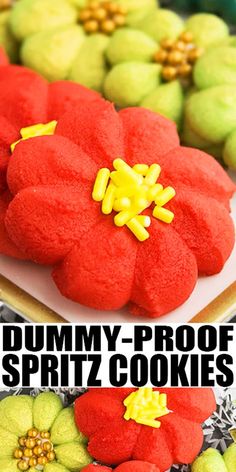 some red and yellow flowers are on top of green cookies with the words, gummy - proof spritz cookies