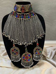 Exquisite Afghan Jewellery Set - Perfect for your Special Occasions Add a touch of exotic elegance to your look with our stunning Afghan jewelry set. Handcrafted by skilled artisans, each piece is a unique work of art that captures the rich cultural heritage of Afghanistan. This set includes a dazzling necklace, matching earrings, and a Tikka headpiece, all intricately designed with traditional Afghan motifs and embellished with vibrant gemstones. Afghan Jewelry Set, Jewellery Set Bridal, Tikka Headpiece, Motifs Afghans, Afghan Jewellery, Trending Necklace, Afghan Dress, Afghan Wedding, Kuchi Jewelry