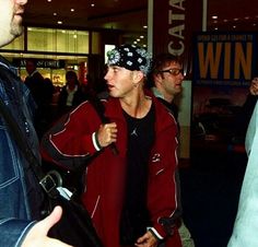 two men talking to each other at an airport