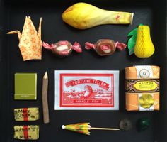 an assortment of candy and other items displayed on a black tray, including banana peels