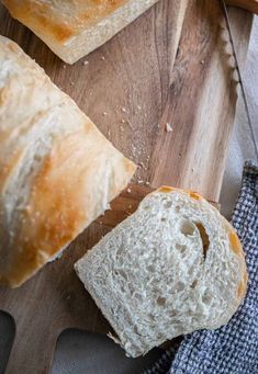 two loaves of bread sitting on top of a cutting board