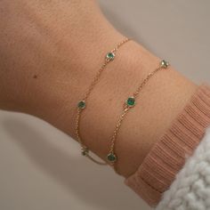 Our new 14k Emerald Yard Bracelet creates a simple yet vibrant pop to your bracelet stack. This bracelet features 5 stunning genuine emeralds and a dainty, yet sturdy chain. 14k Solid Gold and Genuine Emeralds .33 CTW 2.5mm Emerald Dimensions Available in lengths 6.5" and 7" In the wrist photo, this version is the smaller of the two. Due to the handmade nature of this bracelet, please allow 1 - 2 weeks for processing. Emerald Jewelry Bracelet, Timeless Green Bracelet As Gift, Elegant Gemstone Bracelet, Green Emerald Bracelet, Gold Bracelet Wedding, Emerald Bracelet, Emerald Necklace, Dainty Bracelets, Emerald Jewelry