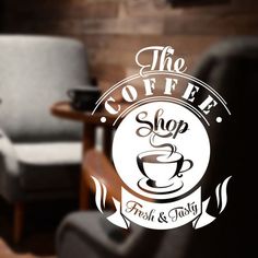 the coffee shop sign is displayed in front of a chair and table with a cup on it