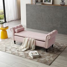 a pink bench sitting on top of a rug