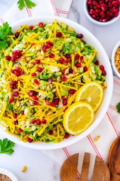 a salad with broccoli, cheese and pomegranates in a white bowl