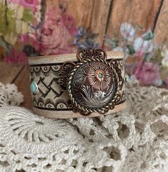 a close up of a bracelet on a doily