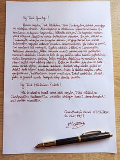 a handwritten letter and fountain pen sitting on top of a piece of white paper