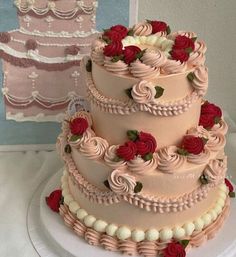 a three tiered cake with red roses on it