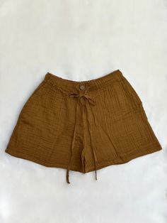 Embrace the essence of summer with our Savannah Tie Shorts, crafted from all-natural gauze cotton that gently wraps around your skin. These women's shorts are designed to provide a feeling of effortless grace and freedom. "Be carefree and spirited." Handmade with care, the Savannah Tie Shorts feature a flexible waistband, a tie waist, and a coconut shell button, offering unmatched comfort. Perfect for any casual outing or beach day, these shorts will be a versatile addition to your wardrobe. Sma Cotton Bottoms For Summer Relaxation, Summer Cotton Pajama Shorts For Relaxation, Cotton Pajama Shorts For Summer Relaxation, Summer Relaxation Bottoms, Short Length, Summer Shorts With Elastic Waistband For Relaxation, Summer Shorts For Relaxation, Summer Casual Shorts, Brown Cotton Beach Bottoms, Brown Cotton Beach Season Bottoms