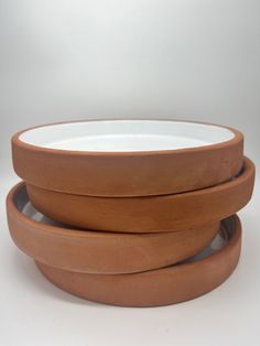 three wooden bowls stacked on top of each other