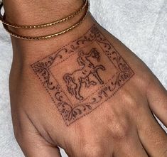 a person's hand with a tattoo on it