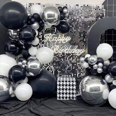 black and white balloons are arranged in the shape of letters