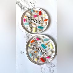 Two (2) Clear Resin Coasters With The Word "Chill" Or "" Featured In Gold Foiled Letters. The Coaster Is Filled With Colorful Assorted Pills And Gold Leafing. Colorful, Vibrant Pills Are Nestled Within Clear Epoxy Resin That Is Both Durable And Chic. The Text In Gold Foil Is Placed Inside The Resin For Optimal Use And Durability. The Colorful Pills Make Them An Ideal Gift For A Doctor, Nurse, Or Pharmacist In Your Life. These Pill Coasters Would Also Make A Perfect Hostess Or Housewarming Gift F Photo Resin Coasters, Pill Coasters, Resin Gift Ideas, Resin Art Coasters, Epoxy Coasters, Clay Inspo, Gold Leafing, Perfect Hostess, Cool Coasters