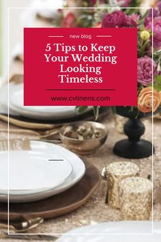 a table set with white plates and silverware, flowers in vases and napkins