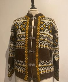 Here is a Amazing beautiful Vintage Cardigan / Knitwear this beautiful Vintage knitwear has long sleeves and has sliver buttons down the front the sliver metal buttons on the front of this vintage cardigan are beautiful and it has a really beautiful pattern in brown, cream, orange, bronze it's a real show stopper for day or night and event.   A great vintage piece for All you great vintage lovers  Measurements :  Approximately  Chest :  20 - Inches  measured 1 side only double for measurements a Nordic Style Long Sleeve Knitted Cardigan, Vintage Knitted Winter Cardigan, Nordic Style Knitted Cardigan For Fall, Nordic Fair Isle Pattern Long Sleeve Cardigan, Ladies Cardigan, Vintage Knitwear, Cardigan Vintage, Vintage Lovers, Button Down Cardigan