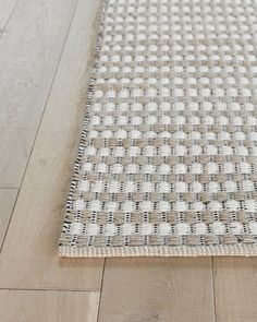 a close up of a rug on the floor with white and brown colors in it