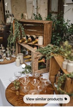 a wooden box filled with wine glasses on top of a table