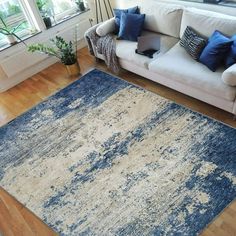 a living room filled with furniture and a blue rug