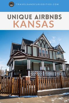 an old house with the words unique arrbns kansas on it and a wooden fence in front