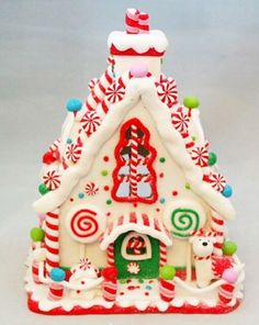 a white and red christmas house with candy canes