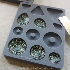 an ice tray with six glass bowls in it