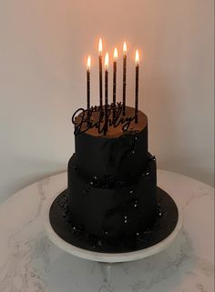 a birthday cake with lit candles on top