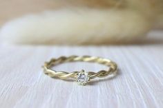 a gold ring with a diamond on it