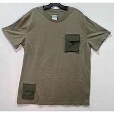 Rue 21 - Men's Short Sleeve T-Shirt With Pockets - Olive Green - Medium -Size: Medium (Men's) -Measurements: Please See Photos Above For All Measurements -Material: Please See Photos For Materials Tag -Condition: New With Tags -Colors May Slightly Vary From Photography Lighting -Will Ship In One Business Day Package Weight: 12 Oz Package Dimensions: 9 X 7 X 2 In I Ship Items Out Every Day So Expect A Quick Delivery! Please Feel Free To Ask Any Questions You May Have. I Answer Most Questions Inst Green Short Sleeve T-shirt With Side Pockets, Crew Neck Shirt With Pockets For Streetwear, Casual Green T-shirt With Side Pockets, Urban Khaki Cotton Tops, Urban Cotton Khaki Tops, Urban Crew Neck Tops With Side Pockets, Urban Short Sleeve Khaki Tops, Urban Khaki Short Sleeve Tops, Khaki Cotton T-shirt For Streetwear