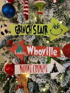 a decorated christmas tree with ornaments and signs on it that read grinch's hair, whoville mount crumpi