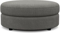 a large grey ottoman sitting on top of a white floor