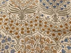 an intricately designed wallpaper with blue and yellow flowers on white background, from the late 19th century