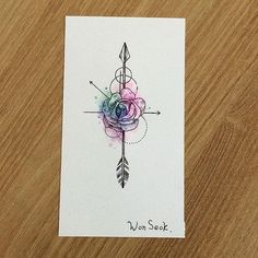 a card with an arrow and rose on the front, in watercolng style