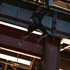 a man flying through the air while riding a skateboard in front of a building