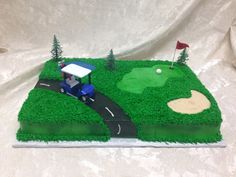 a golf course cake with a car driving on the road