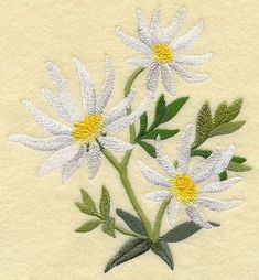 white daisies with green leaves are embroidered onto a piece of cloth, which has been stitched together