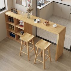 two stools sit at the counter in front of an open kitchen area with shelves