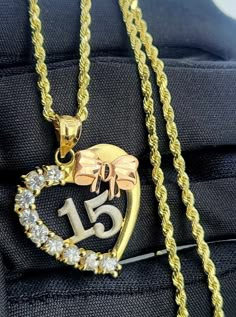 "Sweet 15 14k gold necklace! This set includes a beautiful3 tone heart shaped pendant with the numbers \"15\" in white gold and synthetic zirconio stones, plus a rope necklace. Necklace is 20 inches long by 2mm wide, measurements for the pendant will be on the last slide. 14k gold guaranteed.  Set de cadena para quinceañeras en oro 14k! Este set hermosos inc;uye un corazón en tres tonos con piedras circonios sintéticas y los números \"15\" en oro blanco, con cadena torsal. La cadena mide 20 pulgadas de largo por 2mm de ancho. oro 14k garantizado." 16 Necklace, 15 Necklace, 15 Gold Necklace, Gold 15 Necklace, 15 Jewelry, Sweet 15 Necklace, Quinceanera Necklace Gold, Quince Necklace, Quince Necklace Quinceanera