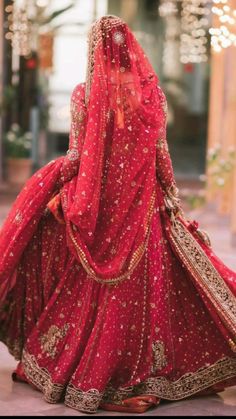 a woman in a red bridal gown