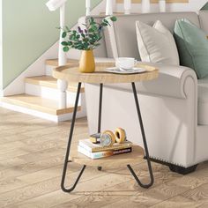 a white couch sitting next to a wooden table on top of a hard wood floor