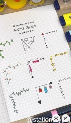 an open notebook with doodle corner designs on it next to markers, pens and pencils