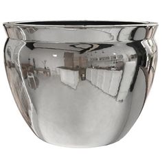 a shiny silver vase is shown against a white background