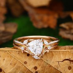 a diamond ring sitting on top of a leaf