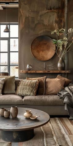 a living room filled with lots of furniture next to a large painting on the wall