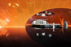 an artistic photo of a futuristic building with orange and black tiles on the walls,