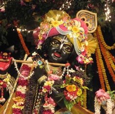 an idol is adorned with flowers and garlands