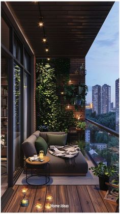 the balcony is decorated with greenery and lit candles for an inviting evening atmosphere in the city