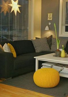 a living room filled with furniture and a star decoration on the wall above the coffee table