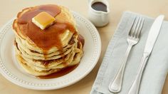 a stack of pancakes with butter and syrup on top